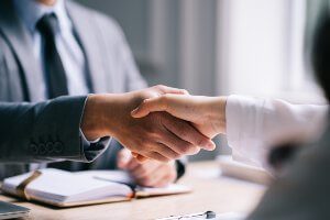 shaking hands at desk 
