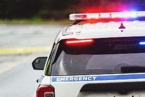 Police car with sirens on. 