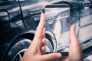 injured victim taking photo of sideswiped vehicle