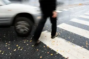 pedestrian in crosswalk with car about to turn