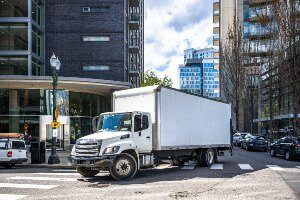 white commercial truck on corner