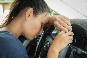 female driver falling asleep on steering wheel
