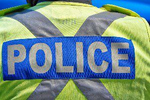 "police" label on back of officer's jacket