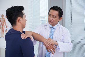 doctor working on patients shoulder